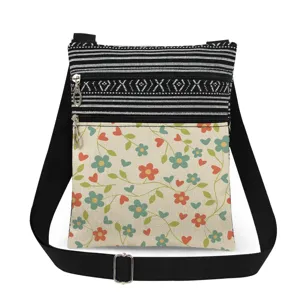 Floral print canvas cross-body bag with double zippers, adjustable strap and messenger style.