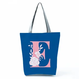 Blue tote bag with pink letter E and floral print detailed view, large capacity shoulder bag