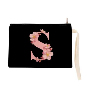 Black canvas zipper pouch with pink cherry blossom letter S print and wrist strap detail.