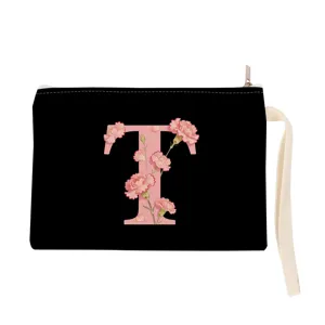 Black canvas cosmetic pouch with pink floral letter print and wrist strap for daily use.