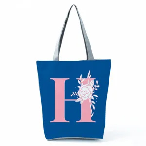 Blue tote bag with pink letter H and floral print, large capacity canvas shoulder bag.