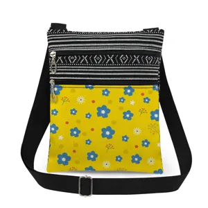 Small floral printed crossbody bag with double zippers, adjustable strap and messenger style.