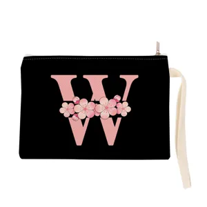 Detailed view of the black canvas cosmetic pouch featuring a pink floral letter W print.