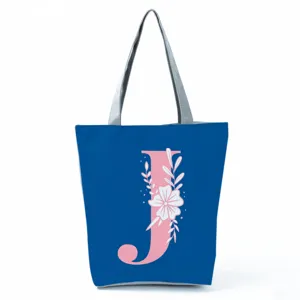 Blue canvas tote bag with pink letter J and white floral print, stylish large capacity handbag.