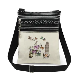 Bolso bandolera de lona con estampado de torre, cremalleras dobles y correa ajustable.
