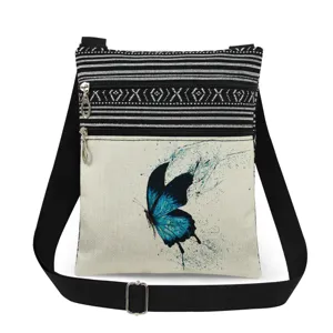 Bolso cruzado de lona con estampado de mariposa azul, bolsillos dobles con cremallera y correa.