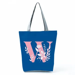 Blue canvas tote bag with pink letter W and floral print, stylish daily shoulder bag.