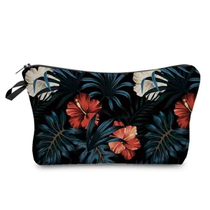 Detail view of the tropical floral print makeup bag showing vibrant red hibiscus pattern.