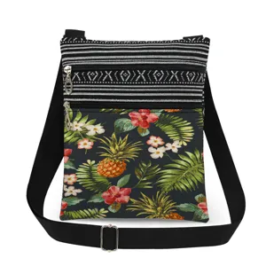 Tropical pineapple floral print crossbody bag with double zippers and adjustable strap detail.