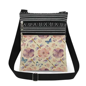 Close-up detail of the double zipper crossbody bag featuring floral and dragonfly print.