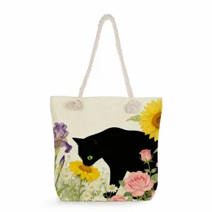 Black cat print canvas tote bag with thick rope handle, stylish floral shoulder bag detail.