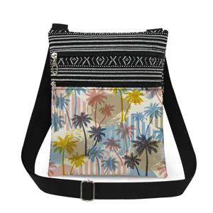 Detailed view of tropical palm tree print canvas crossbody bag with black adjustable strap.