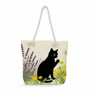 Close-up detail of the canvas tote bag featuring a cute black cat and floral print.