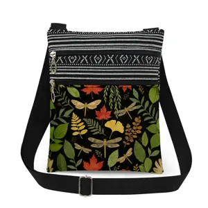 Close-up detail of the canvas crossbody bag featuring vibrant dragonfly and autumn leaf print.