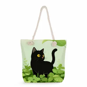 Black cat print tote bag detail showing green leaf illustration and thick rope handles design.