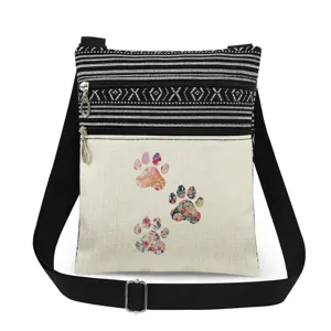 Sac bandoulière en toile avec motif de patte florale, double fermeture et sangle réglable.