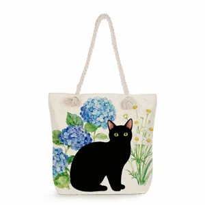 Canvas tote bag with cute black cat and floral watercolor print, perfect beach shoulder bag.