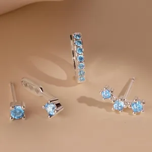 Close-up detail shot of light blue crystal copper stud earrings set for women daily look.