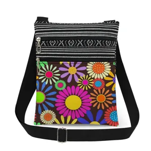 Close-up detail of the colorful retro floral print crossbody bag, showing double zippers and strap.