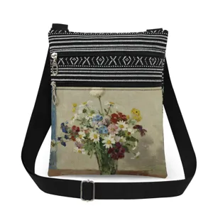 Close-up of the double zipper and adjustable strap on the floral print messenger bag.