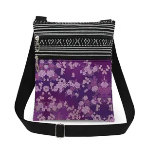 Small purple floral print crossbody shoulder bag with double zippers and adjustable strap.