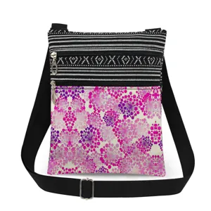 Detail view of small crossbody bag featuring pink floral print and black adjustable strap.