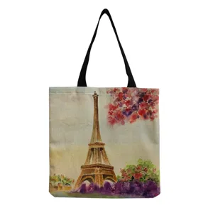 Detailed view of the watercolor Eiffel Tower print on fabric, showing art details and black strap.