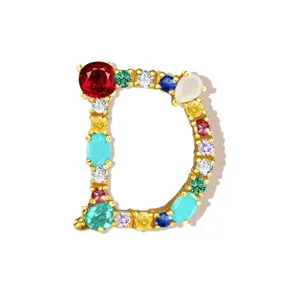 Detailed view of gold-tone letter D pendant encrusted with vibrant colorful cubic zirconia stones.