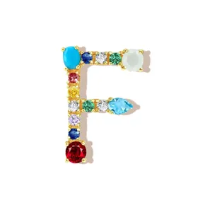Detailed close-up of a colorful gemstone letter F pendant necklace charm with cubic zirconia.