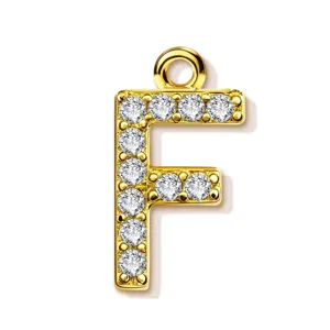 Gold tone letter F pendant close-up, sparkling rhinestone alphabet accessory detail view.