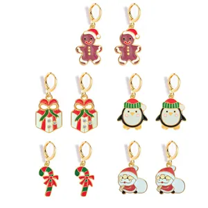 Detailed view of exquisite Christmas enamel earrings with sparkling rhinestone holiday decorations.