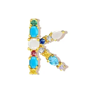 Close-up detail of the colorful gemstone letter K pendant showcasing sparkling cubic zirconia.