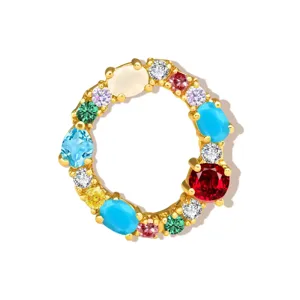 Detailed view of colorful cubic zirconia letter pendant charm, gold plated copper fashion jewelry.