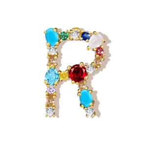 Gold-plated letter R pendant detail, sparkling multi-color cubic zirconia gemstone charm.