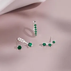 Close-up detail shot of exquisite green gemstone stud earrings and hoop set for women.
