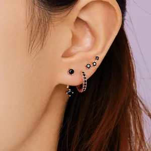 Rose gold copper multi piercing earrings set with black stones, stylish fashion ear jewelry.