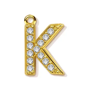 Close up detail of gold plated letter K pendant, paved with sparkling round zirconias.