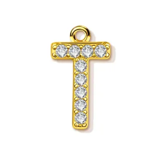 Close-up detail shot of the elegant gold-plated letter T pendant sparkling with crystal stones.