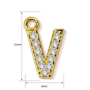 Detail view of the elegant letter V pendant, sparkling stone paved copper fashion accessory.