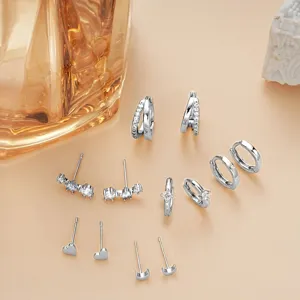 Silver stud and hoop earrings set detailed view, showcasing multiple delicate crystal designs.