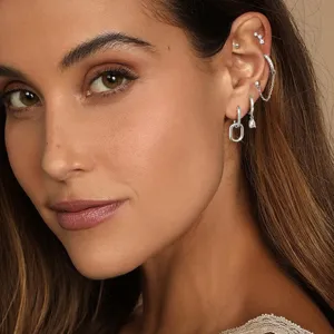 Detailed view of women's silver cartilage earring set with sparkling crystals and chain.