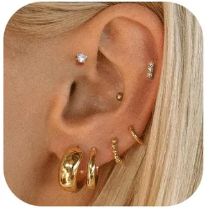 Detail view of stylish gold hoop earrings and stud set, perfect for stacking and modern daily wear.
