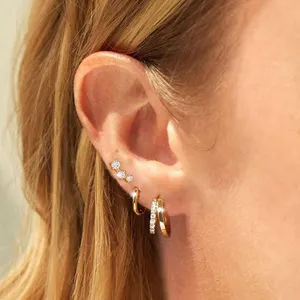 Gold hoop earrings set for women, minimalist daily wear jewelry featuring sparkling small huggies.