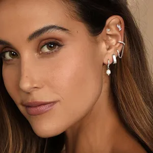 Silver multi-piece earring set featuring pearl drop hoop, cartilage cuffs, and sparkling studs.