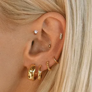 Gold hoop earrings set detail view, stylish metallic ear jewelry for women daily wear.