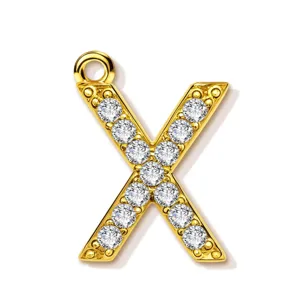 Detailed view of the sparkling gold-plated letter X pendant, micro-paved with clear cubic zirconia.