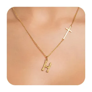 Detail shot of the gold letter H pendant and side cross necklace, delicate clavicle chain.