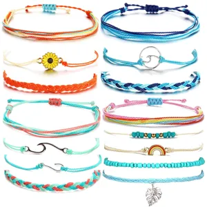 Detailed view of colorful woven cord bracelets set with various charms like sun and wave.