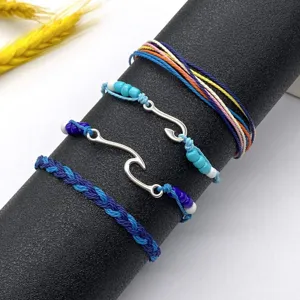 Handmade woven surf bracelet set with wave charms and colorful braided ropes for daily wear.