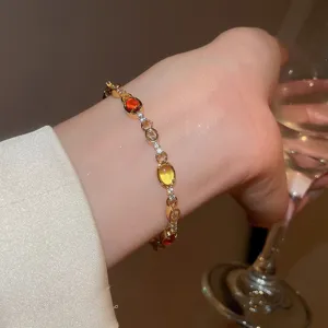 Detailed shot of a luxury gold-plated bracelet with colorful oval and round cubic zirconia.